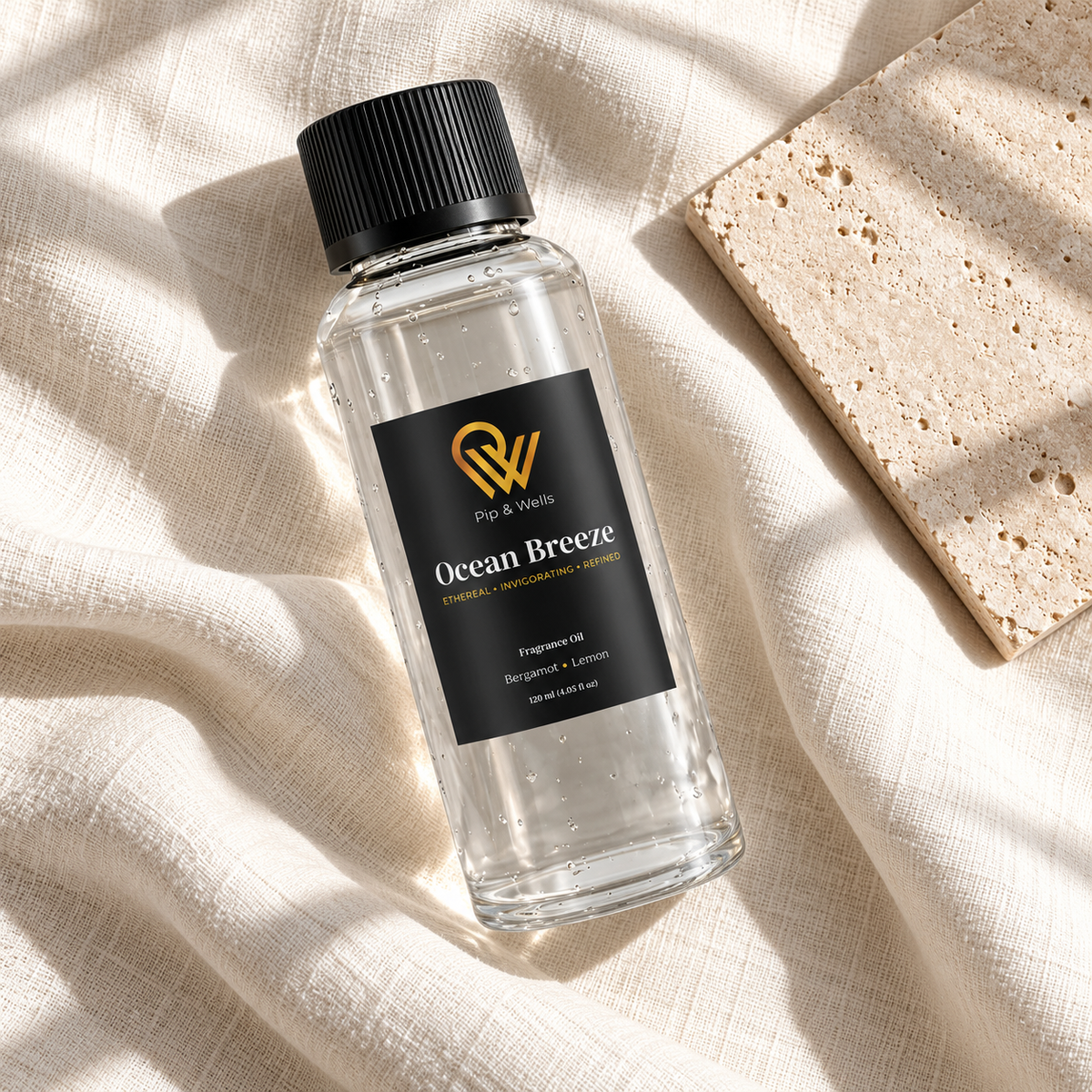 Pip & Wells Ocean Breeze 120 ml fragrance oil bottle on light linen beside a textured stone tile